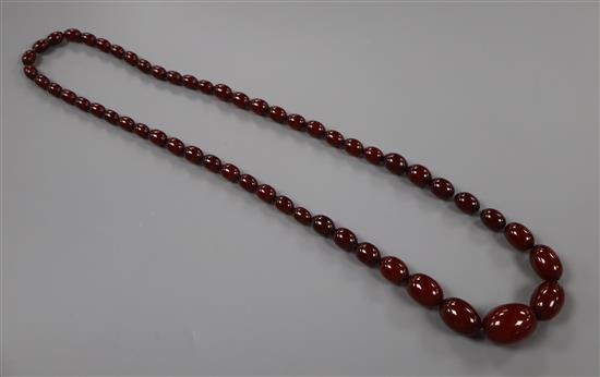 A single strand graduated simulated cherry amber bead necklace, 72cm, gross 61 grams.